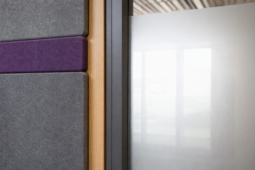 Acoustic panels beside frosted meeting-room glass