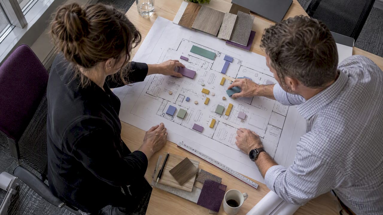 Executives arranging office neighbourhood zones