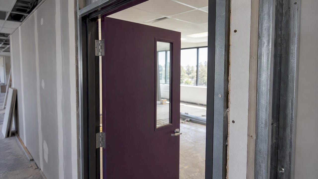 Fire door set within an office partition