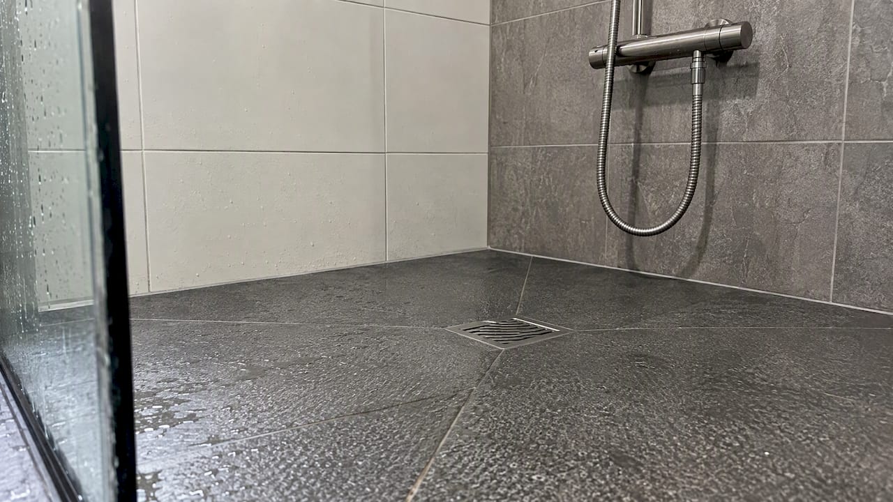 Textured shower flooring and metal fitting